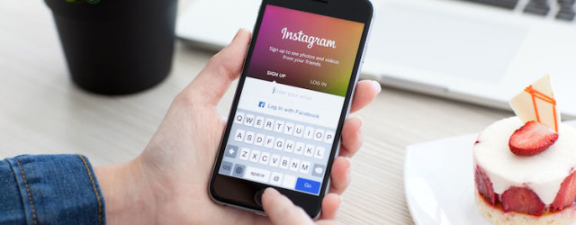 Woman holding iPhone 6 Space Gray with service Instagram